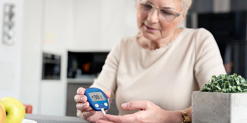 senior woman checking her blood sugar