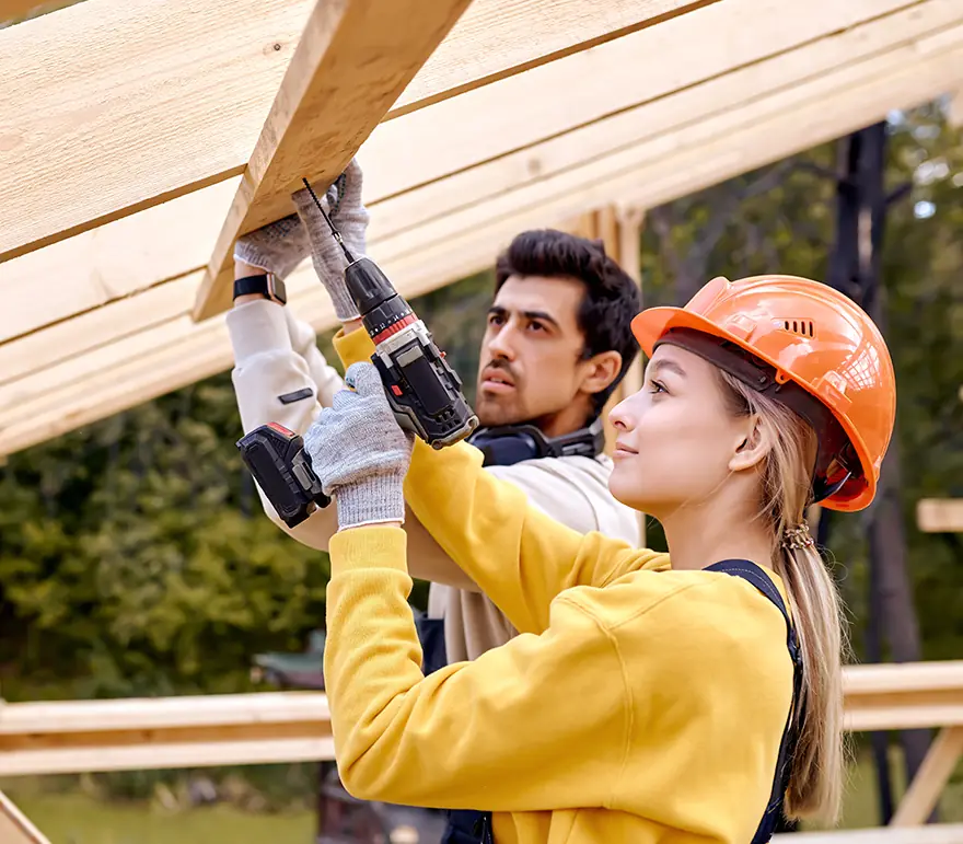 young carpenters drilling into wood
