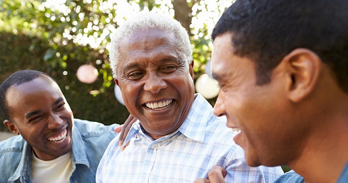 senior man laughing with his family