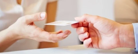 handing over insurance card to front desk