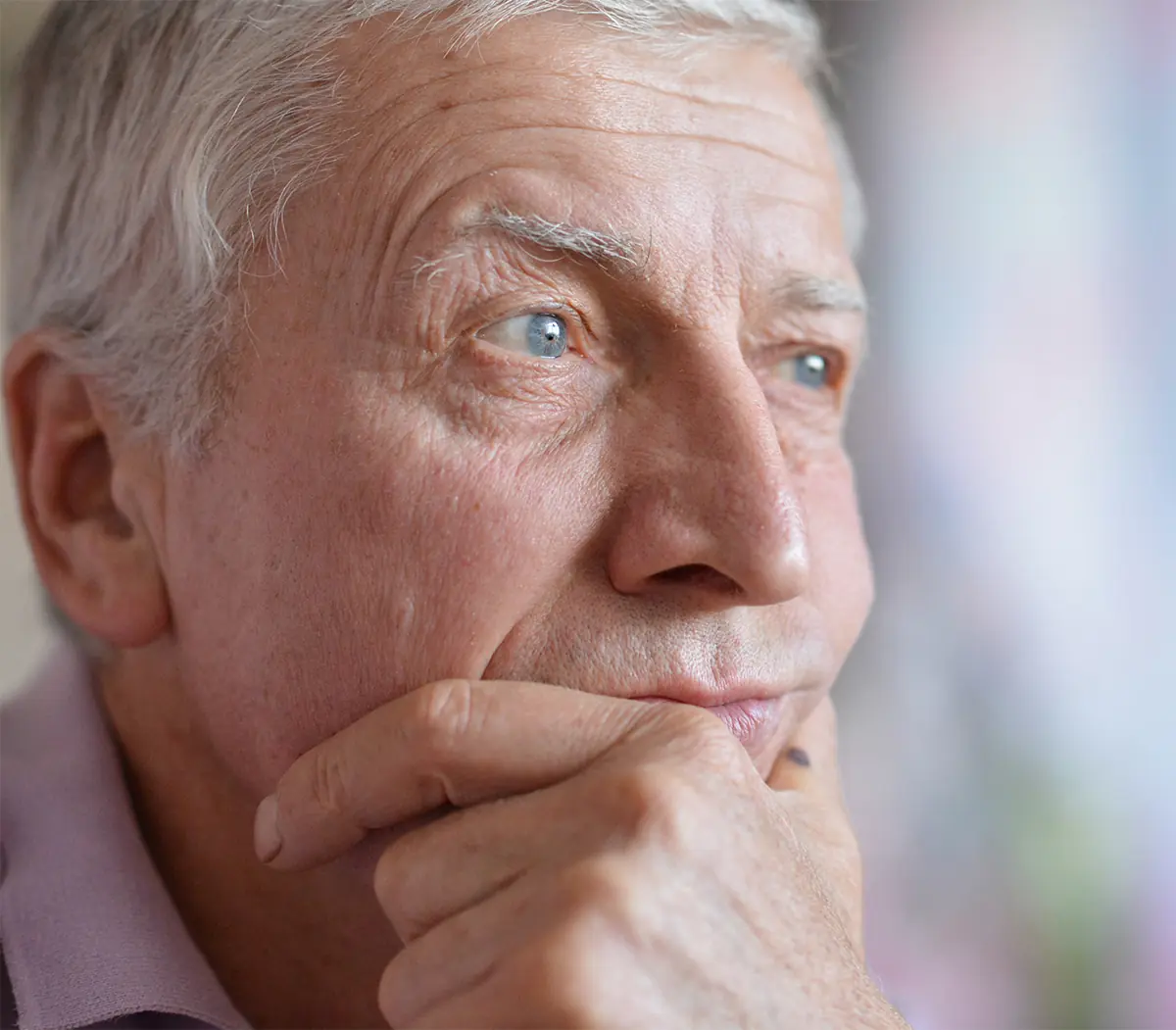 pensive senior man looking off to the side