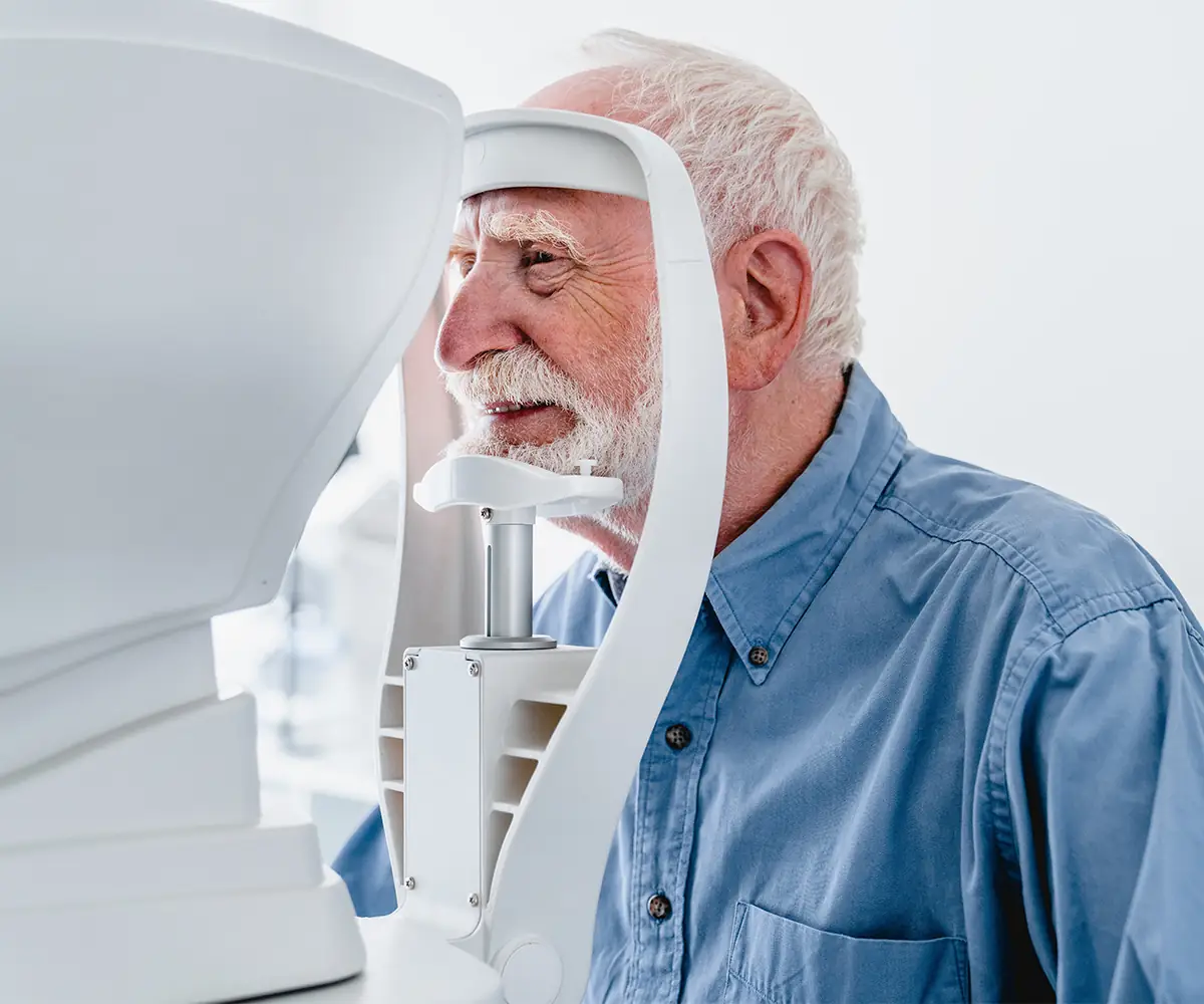 Elderly male patient undergoing diagnostic eye examination