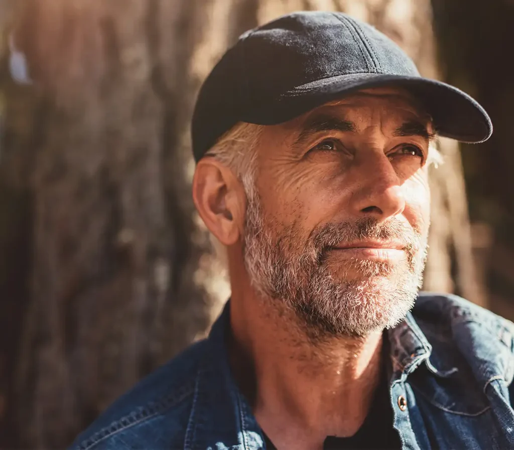 pensive senior man in the woods